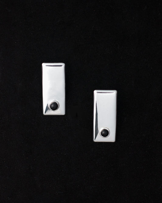 A pair of 925 sterling silver onyx earrings against a black background.