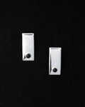A pair of 925 sterling silver onyx earrings against a black background.